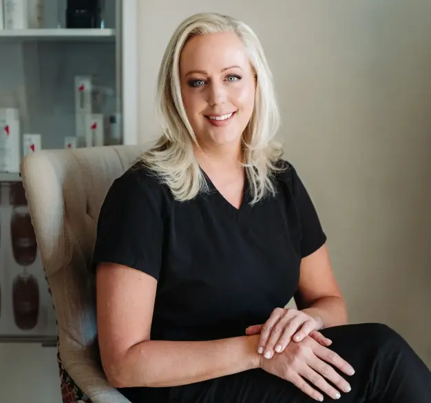Dr. Heather Jenkins smiles in her dental office in Englewood, Colorado.